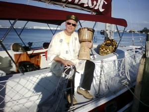 Buddy Helm sitting with Drum on the yacht Magic